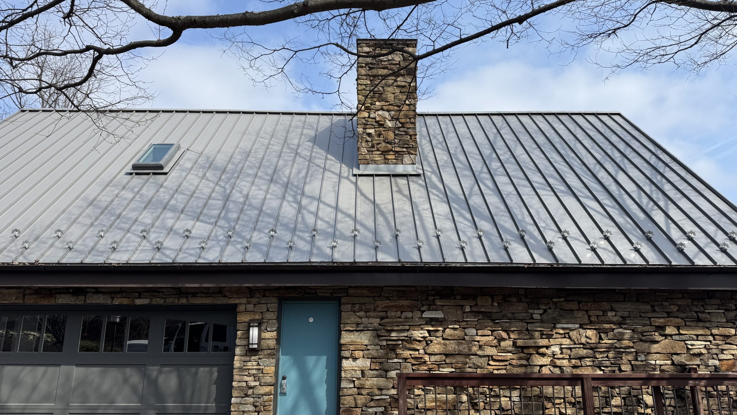 Residential roof washing service in progress, cleaning shingles