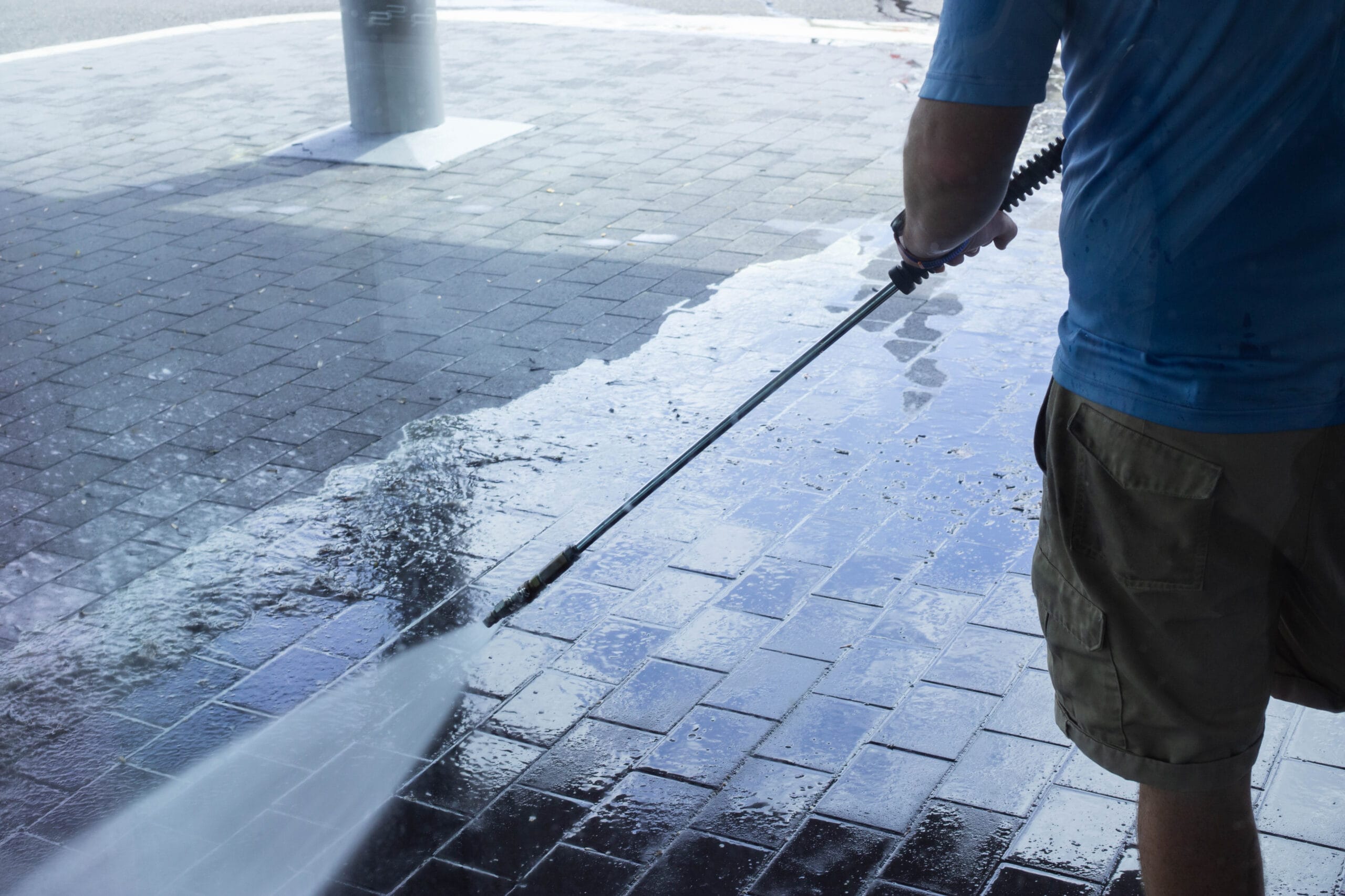 Commercial power washing service cleaning a brick building exterior
